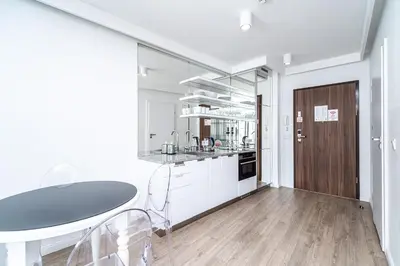a kitchen with a table and a table and chairs at RentPlanet - Apartament Dębniki in Kraków