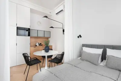 a bedroom with a bed and a table and chairs at Apartament Kazimierz Mostowa in Kraków