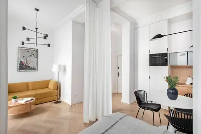 a living room with a couch and a table at Apartament Kazimierz Mostowa in Kraków