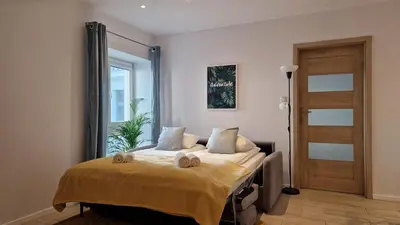 a bedroom with a bed with two towels on it at Perfect Location Comfort Apartment City Beat#10 in Kraków