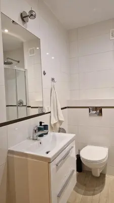 a white bathroom with a sink and a toilet at Perfect Location Comfort Apartment City Beat#10 in Kraków