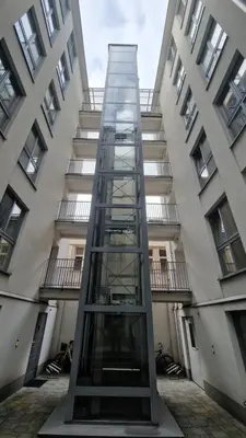 a glass elevator in front of a building at Perfect Location Comfort Apartment City Beat#10 in Kraków