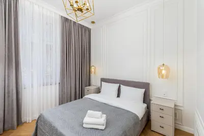 a bedroom with a bed with two towels on it at Vistula River Deluxe Apartment by BookingHost in Kraków