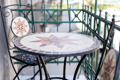 a table and two chairs on a balcony at Vistula River Deluxe Apartment by BookingHost in Kraków