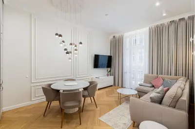 a living room with a couch and a table at Vistula River Deluxe Apartment by BookingHost in Kraków