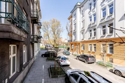 a city street with cars parked on the street at Vistula River Deluxe Apartment by BookingHost in Kraków