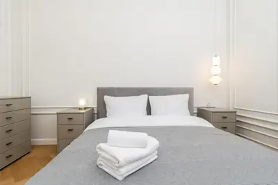 a bedroom with a bed with white towels on it at Vistula River Deluxe Apartment by BookingHost in Kraków
