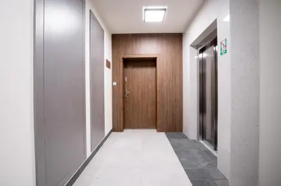 a hallway with a door and a tile floor at Walerego Sławka Cosy Studio by BookingHost in Kraków