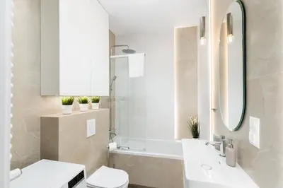 a bathroom with a sink and a toilet and a mirror at Walerego Sławka Cosy Studio by BookingHost in Kraków