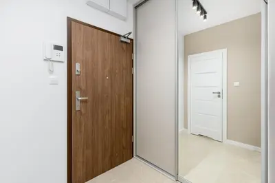 a sliding glass door in a room with a hallway at Walerego Sławka Cosy Studio by BookingHost in Kraków