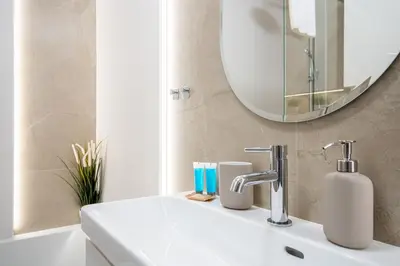 a bathroom with a sink and a mirror at Walerego Sławka Cosy Studio by BookingHost in Kraków