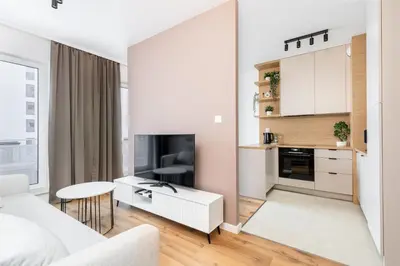 a white living room with a white couch and a table at Walerego Sławka Cosy Studio by BookingHost in Kraków
