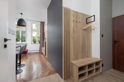 a room with a closet with a wooden door at Studio Apartment - Dietla 21 street in Kraków