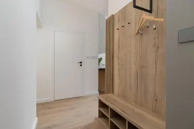 a room with a wooden wall with a wooden bench at Studio Apartment - Dietla 21 street in Kraków