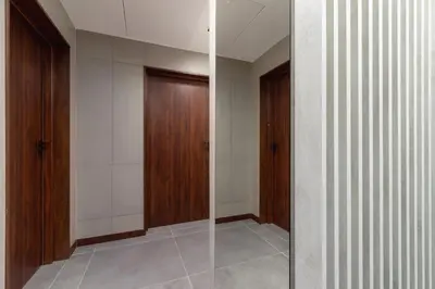 a walk in shower in a room with wooden doors at Studio Apartment - Dietla 21 street in Kraków