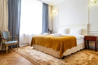 a hotel room with a bed and a chair and a window at Househost Apt: Starowiślna 75/3/2 in Kraków