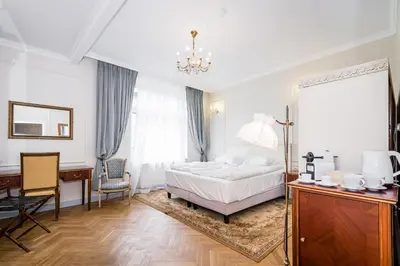 a bedroom with a bed and a desk and a mirror at Househost Apt: Starowiślna 75/3/2 in Kraków