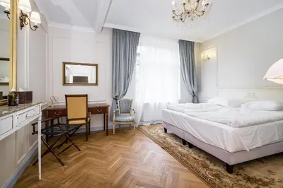 a hotel room with a bed and a desk and a desk at Househost Apt: Starowiślna 75/3/2 in Kraków