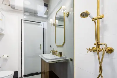 a bathroom with a sink and a shower at Househost Apt: Starowiślna 75/3/2 in Kraków