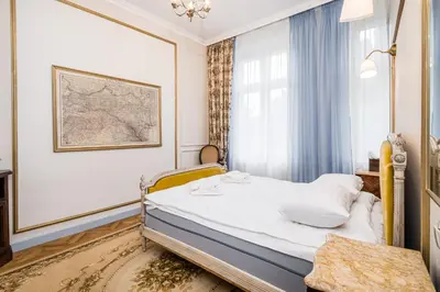 a small bedroom with a bed and a window at Househost Apt: Starowiślna 75/3/2 in Kraków