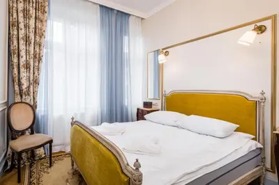 a bedroom with a bed and a chair and a window at Househost Apt: Starowiślna 75/3/2 in Kraków