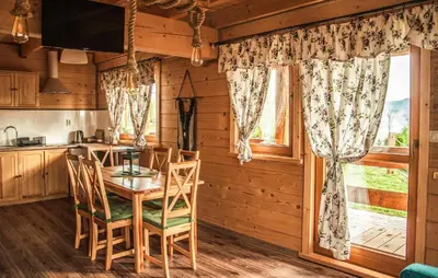 a dining room with a table and chairs and a window at Awesome Home In Slopnice With Sauna in Słopnice
