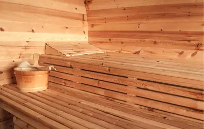 a wooden tub in a sauna with a bucket at Awesome Home In Slopnice With Sauna in Słopnice