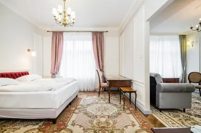 a hotel room with a bed and a chair at Househost Apt: Starowiślna 75/3/1 in Kraków