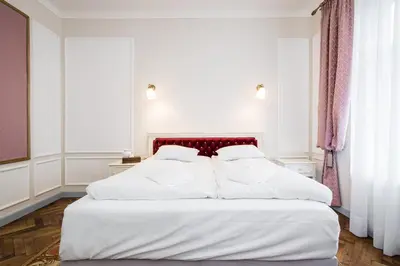 a bedroom with a large white bed with a red headboard at Househost Apt: Starowiślna 75/3/1 in Kraków