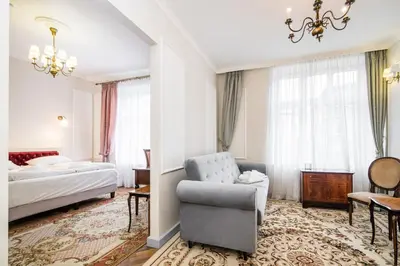 a hotel room with a bed and a chair at Househost Apt: Starowiślna 75/3/1 in Kraków