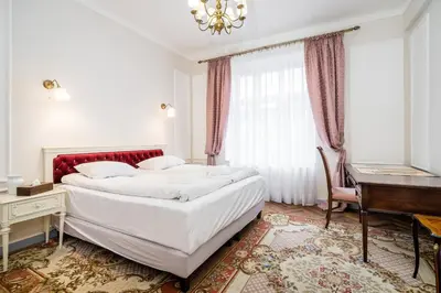 a bedroom with a bed and a desk and a piano at Househost Apt: Starowiślna 75/3/1 in Kraków