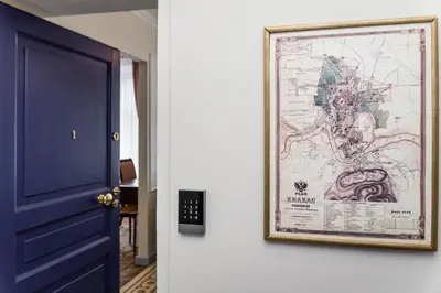 a picture hanging on a wall next to a blue door at Househost Apt: Starowiślna 75/3/1 in Kraków