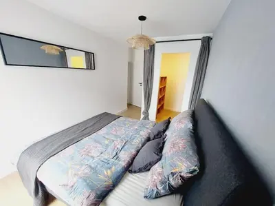 a bedroom with a bed in a room with a window at Przestronny apartament, ogródek, bezpłatne miejsca postojowe w garażu, AWG APARTMENTS in Kraków