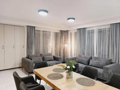 a living room with a couch and a table at Przestronny apartament, ogródek, bezpłatne miejsca postojowe w garażu, AWG APARTMENTS in Kraków