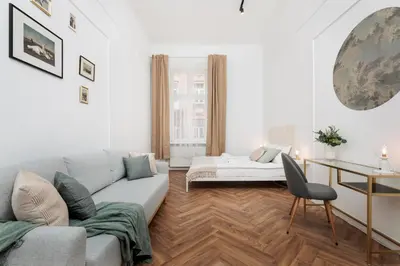 a living room with a couch and a table at Spacious & Modern 6 Bedroom Apartment - Around The Main Market Square - by Upstairs in Kraków