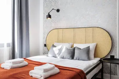 a bedroom with a bed with two towels on it at Spacious & Modern 6 Bedroom Apartment - Around The Main Market Square - by Upstairs in Kraków