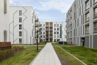 a walkway between two buildings in a city at Lema 19 Uniqe Apartment in Krakow with Garden Air Conditioning Parking near Tauron Arena by Renters Prestige in Kraków