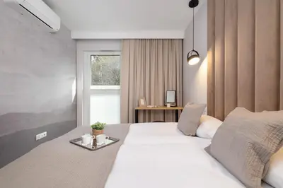 a bedroom with a white bed with a tray on it at Lema 19 Uniqe Apartment in Krakow with Garden Air Conditioning Parking near Tauron Arena by Renters Prestige in Kraków