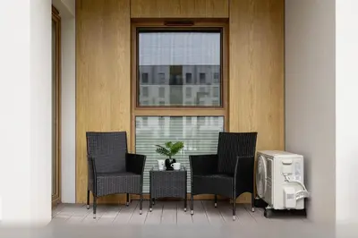 a patio with a table and chairs and a window at Lema 19 Uniqe Apartment in Krakow with Garden Air Conditioning Parking near Tauron Arena by Renters Prestige in Kraków