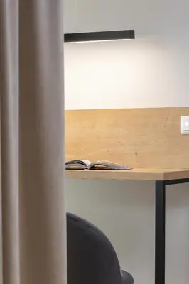 a desk with a book and a notebook on it at Lema 19 Uniqe Apartment in Krakow with Garden Air Conditioning Parking near Tauron Arena by Renters Prestige in Kraków