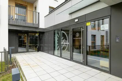a facade of a building with glass doors at Lema 19 Uniqe Apartment in Krakow with Garden Air Conditioning Parking near Tauron Arena by Renters Prestige in Kraków