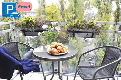 a plate of bread on a table on a balcony at Przystań Dolnych Młynów in Kraków