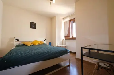 a bedroom with a bed with yellow pillows and a glass table at Przystań Dolnych Młynów in Kraków