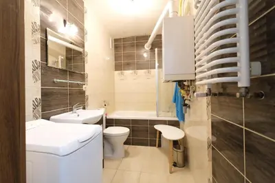 a bathroom with a sink and a toilet and a tub at Przystań Dolnych Młynów in Kraków