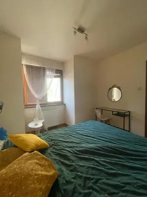 a bedroom with a large green bed with a window at Przystań Dolnych Młynów in Kraków