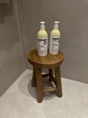 two bottles of milk sitting on a stool at Tu - Lum Apartament in Kraków