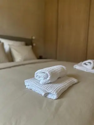 two towels sitting on top of a bed at Tu - Lum Apartament in Kraków