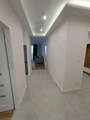 an empty living room with a white wall at APARTAMENTY HEMMA ORAWSKA 14 in Kraków