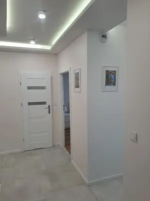 a room with white walls and a white door at APARTAMENTY HEMMA ORAWSKA 14 in Kraków