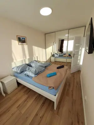 a bedroom with a large bed with a mirror at APARTAMENTY HEMMA ORAWSKA 14 in Kraków